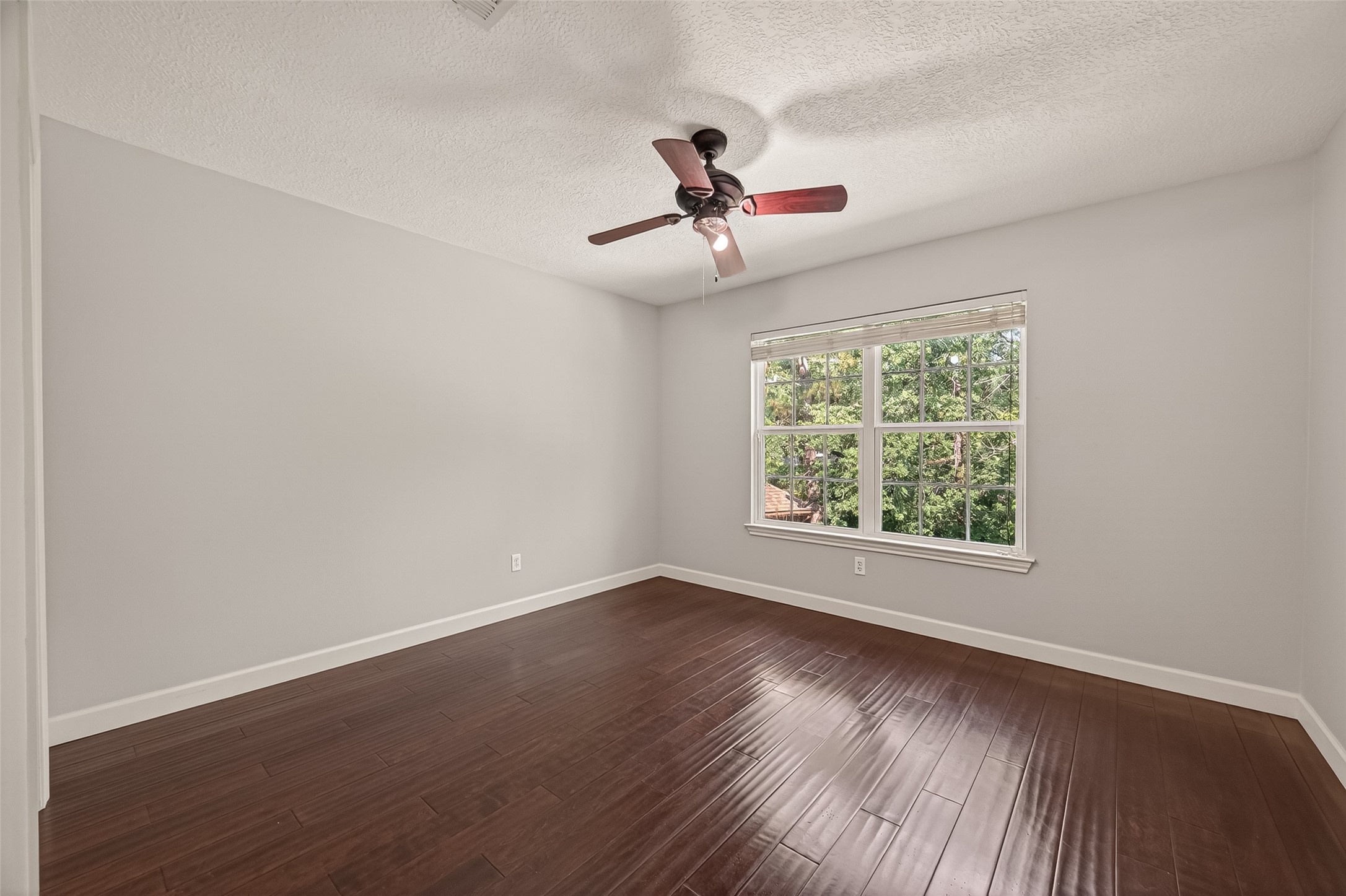 6131 Hampton Way Court Spring, TX 77389 - Photo 29 of 50 a view of an empty room with wooden floor and a window
