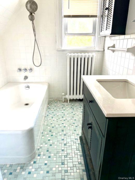 265 Mayflower Avenue, Unit 1 New Rochelle, NY 10801 - Photo 12 of 15 a bathroom with a sink a toilet and a bathtub