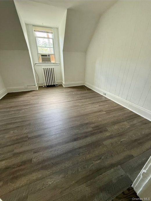 265 Mayflower Avenue, Unit 1 New Rochelle, NY 10801 - Photo 9 of 15 an empty room with wooden floor and windows