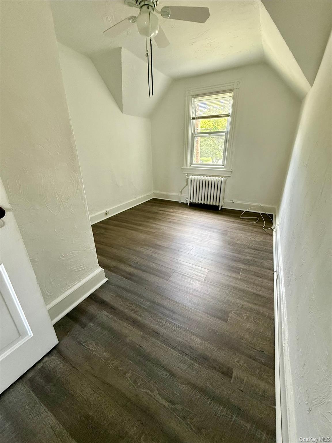 265 Mayflower Avenue, Unit 1 New Rochelle, NY 10801 - Photo 10 of 15 an empty room with wooden floor and windows