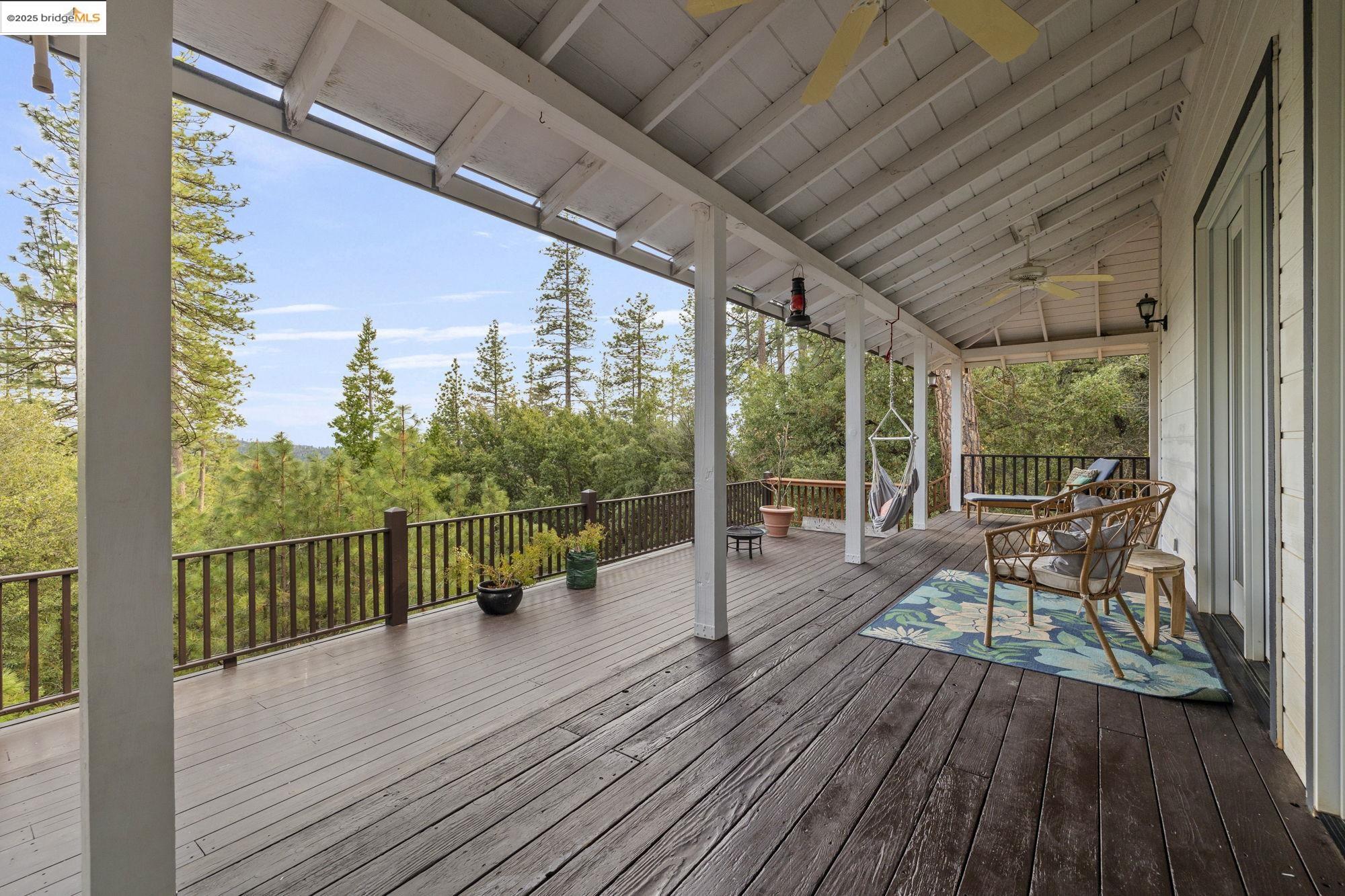 a view of a balcony with chairs and wooden floor