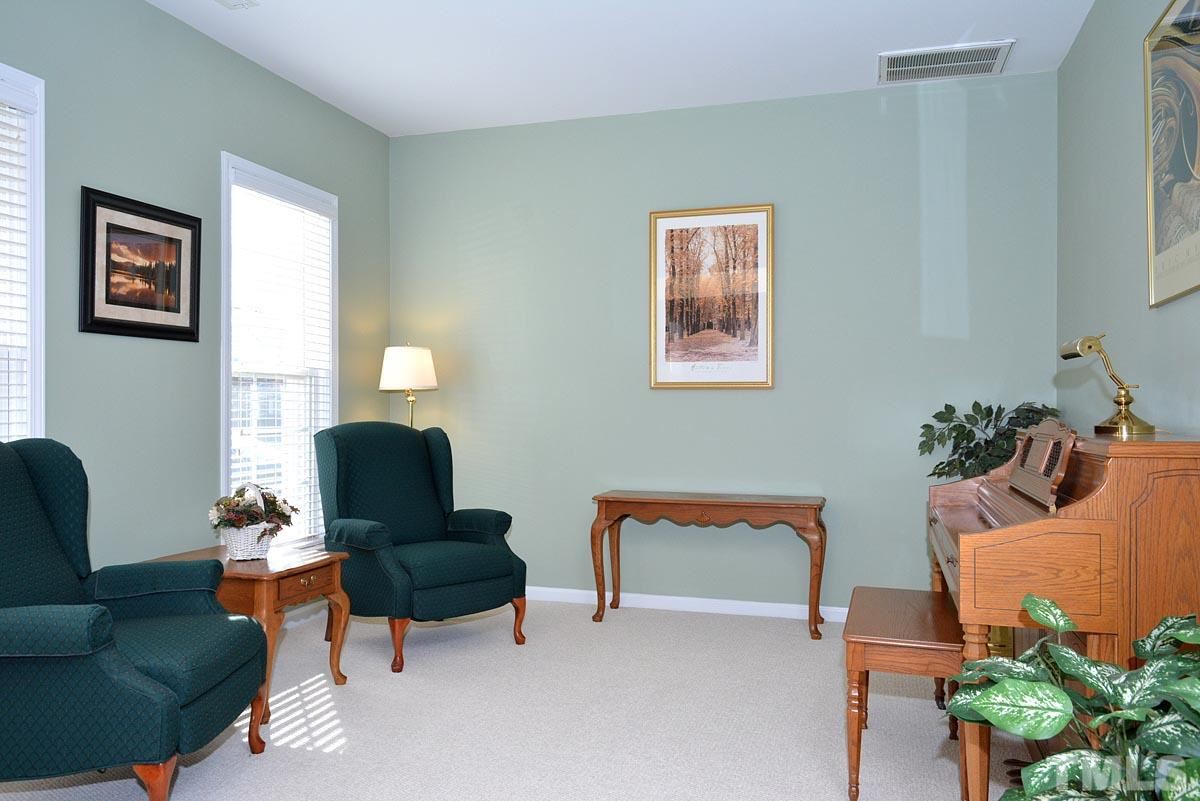 7748 Silver View Lane Raleigh, NC 27613 - Photo 3 of 25 a living room with furniture and a potted plant