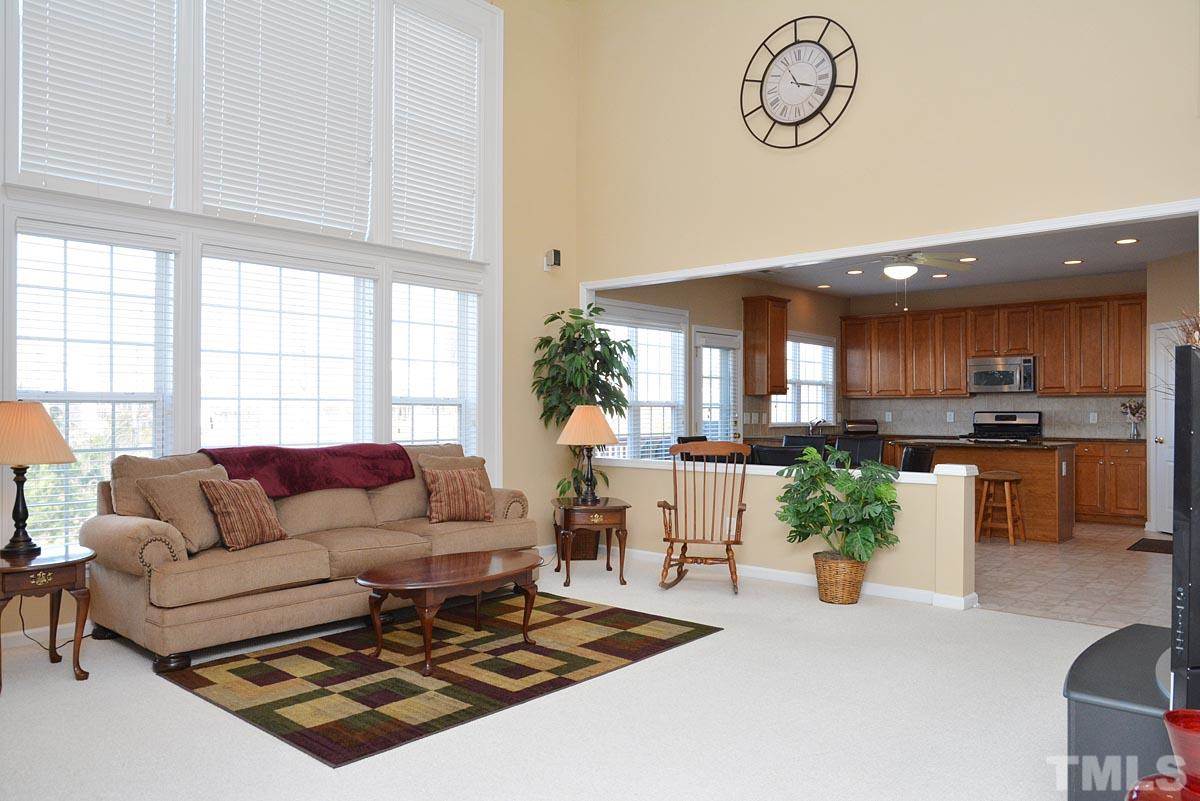 7748 Silver View Lane Raleigh, NC 27613 - Photo 8 of 25 a living room with furniture kitchen view and large windows