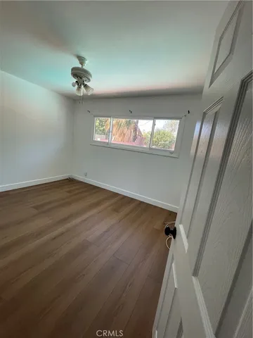 a bathroom with a toilet sink vanity and mirror