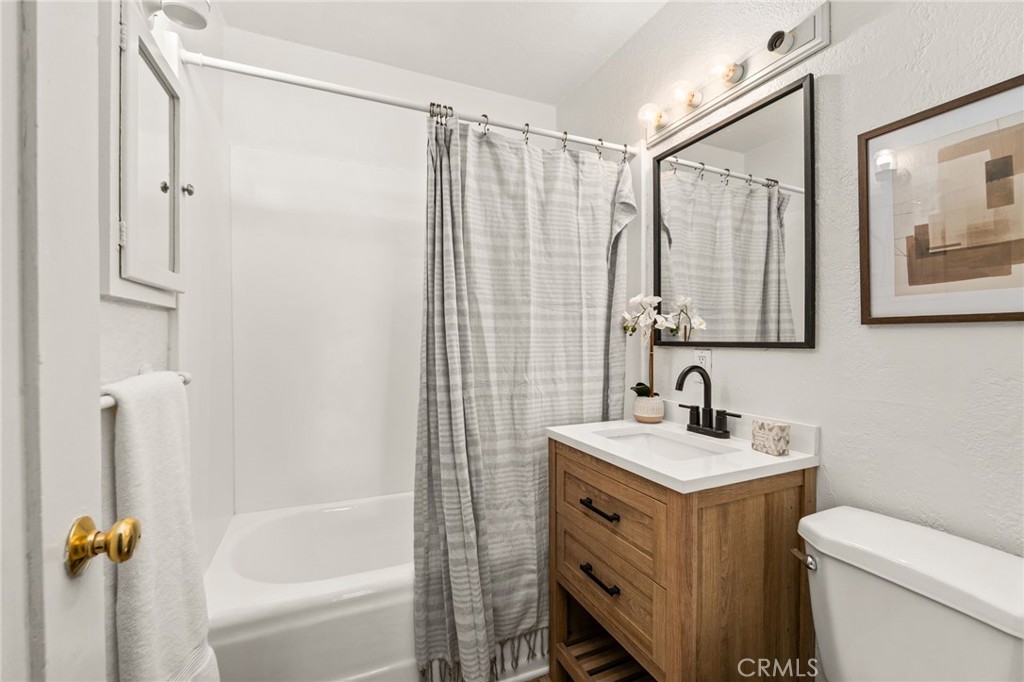 616 Monterey Street Redlands, CA 92373 - Photo 9 of 20 a bathroom with a sink mirror vanity and toilet
