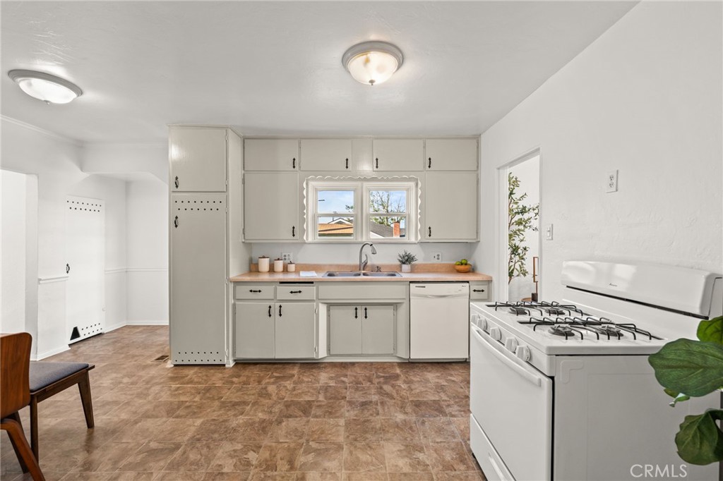616 Monterey Street Redlands, CA 92373 - Photo 10 of 20 a kitchen with granite countertop a sink stove and cabinets