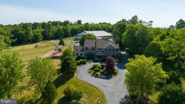 an aerial view of a house with a yard basket ball court and outdoor seating