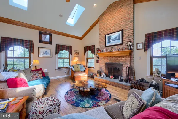 a living room with furniture fireplace and window