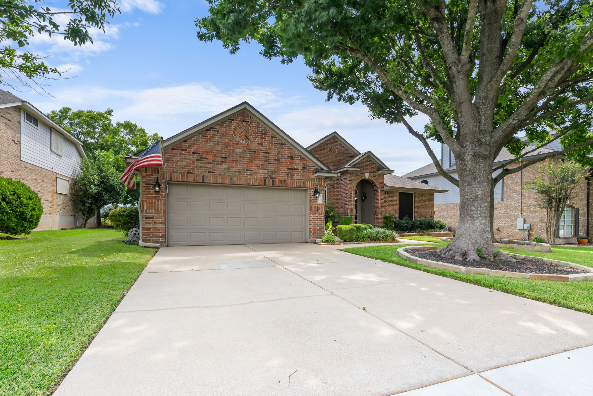 a front view of a house with a yard and garage