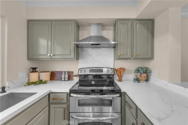 a kitchen with granite countertop a stove top oven and cabinets