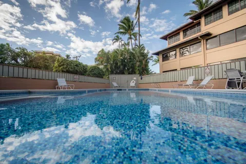 a view of a swimming pool with palm trees