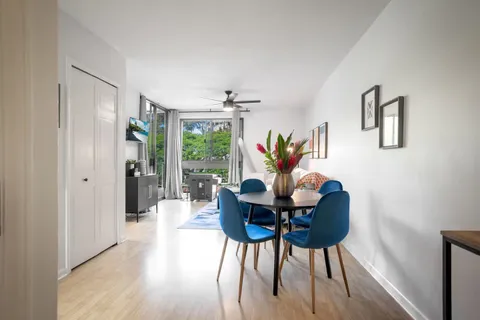 a dining room with furniture and wooden floor