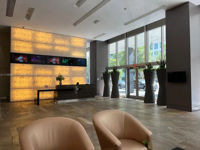 a living room with couches and a flat screen tv