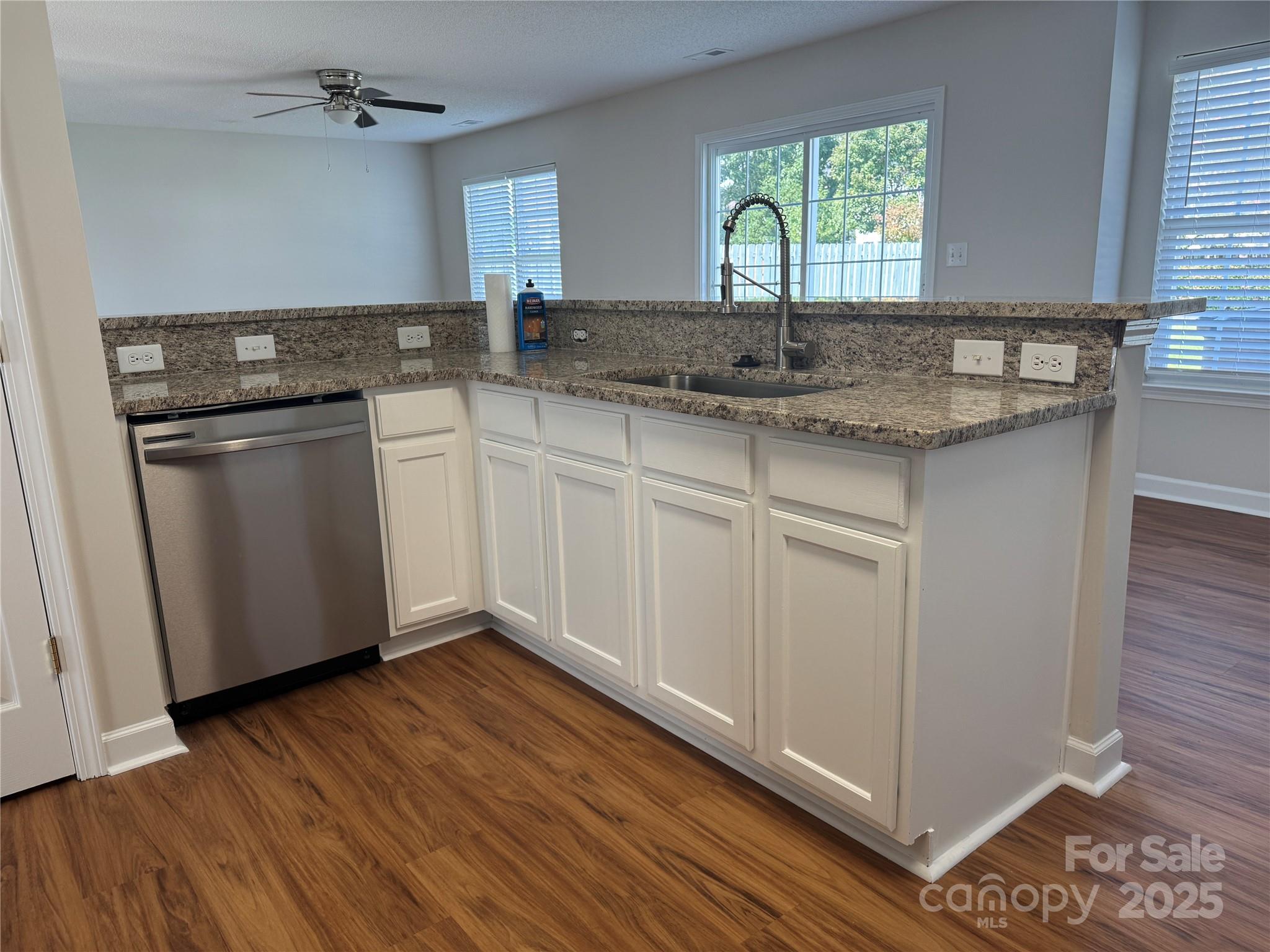 5506 Rogers Road Indian Trail, NC 28079 - Photo 12 of 30 a kitchen with granite countertop a sink and cabinets