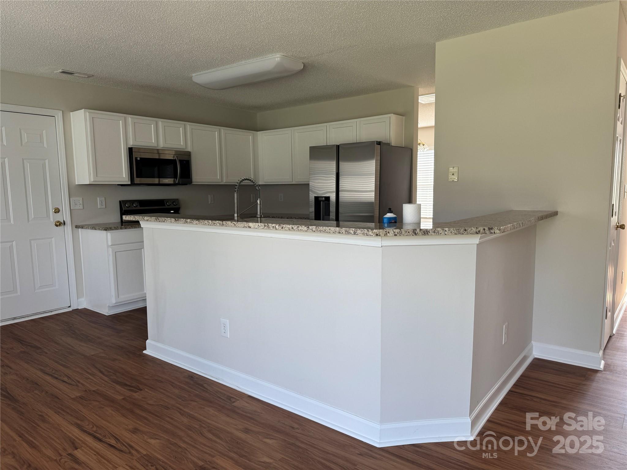 5506 Rogers Road Indian Trail, NC 28079 - Photo 15 of 30 a kitchen with stainless steel appliances a sink and microwave