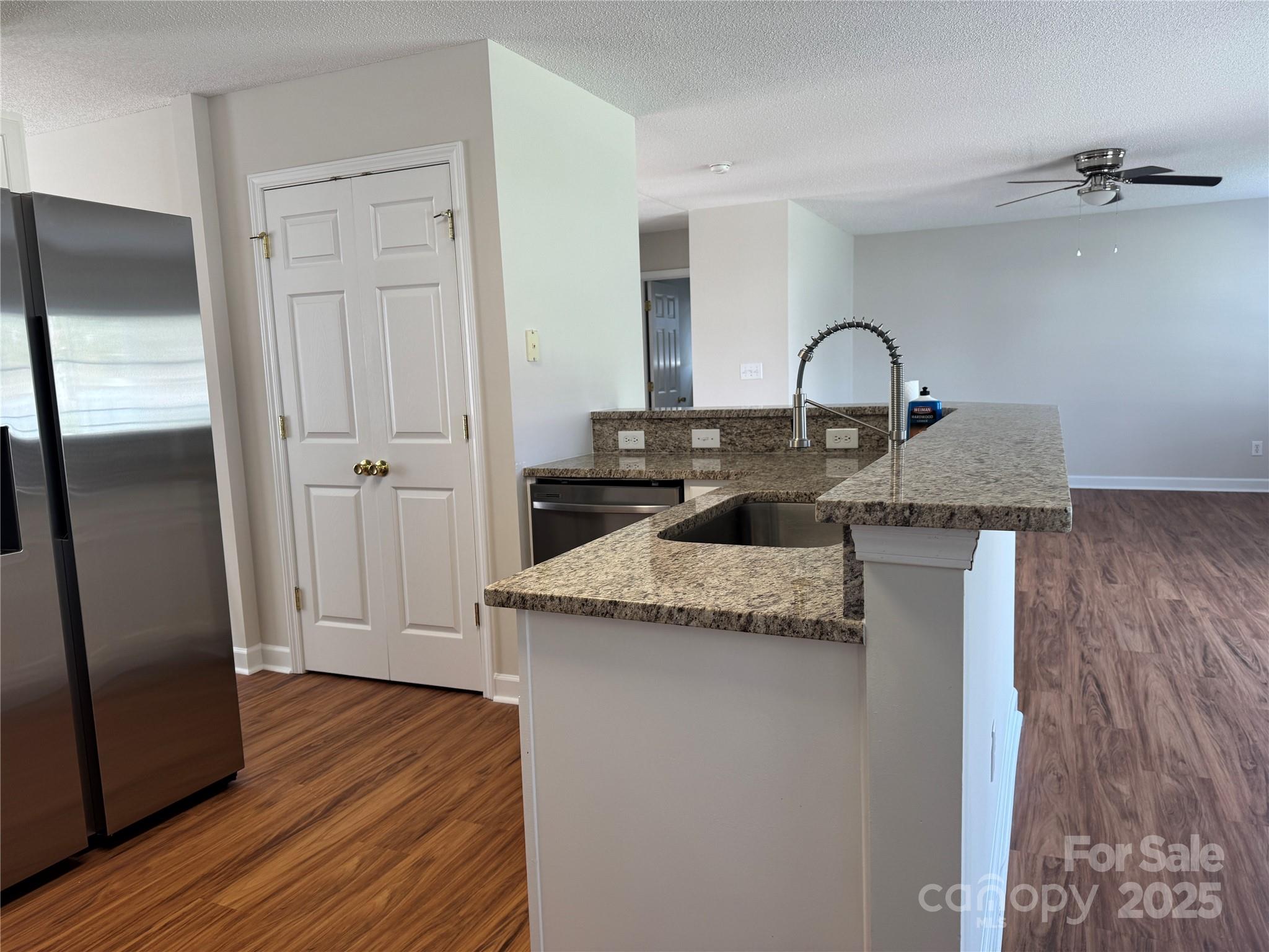 5506 Rogers Road Indian Trail, NC 28079 - Photo 16 of 30 a kitchen with granite countertop a sink and a refrigerator