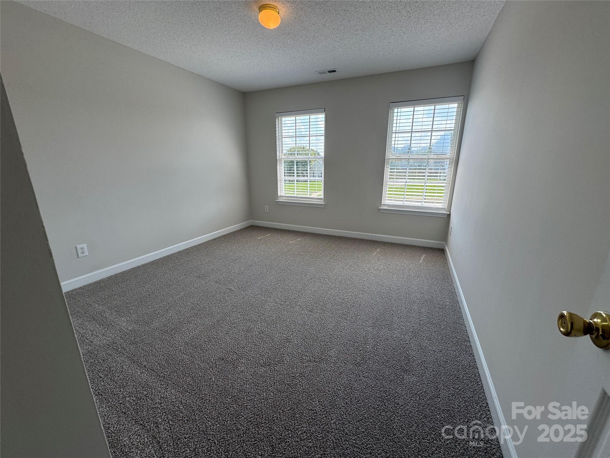 5506 Rogers Road Indian Trail, NC 28079 - Photo 18 of 30 an empty room with windows