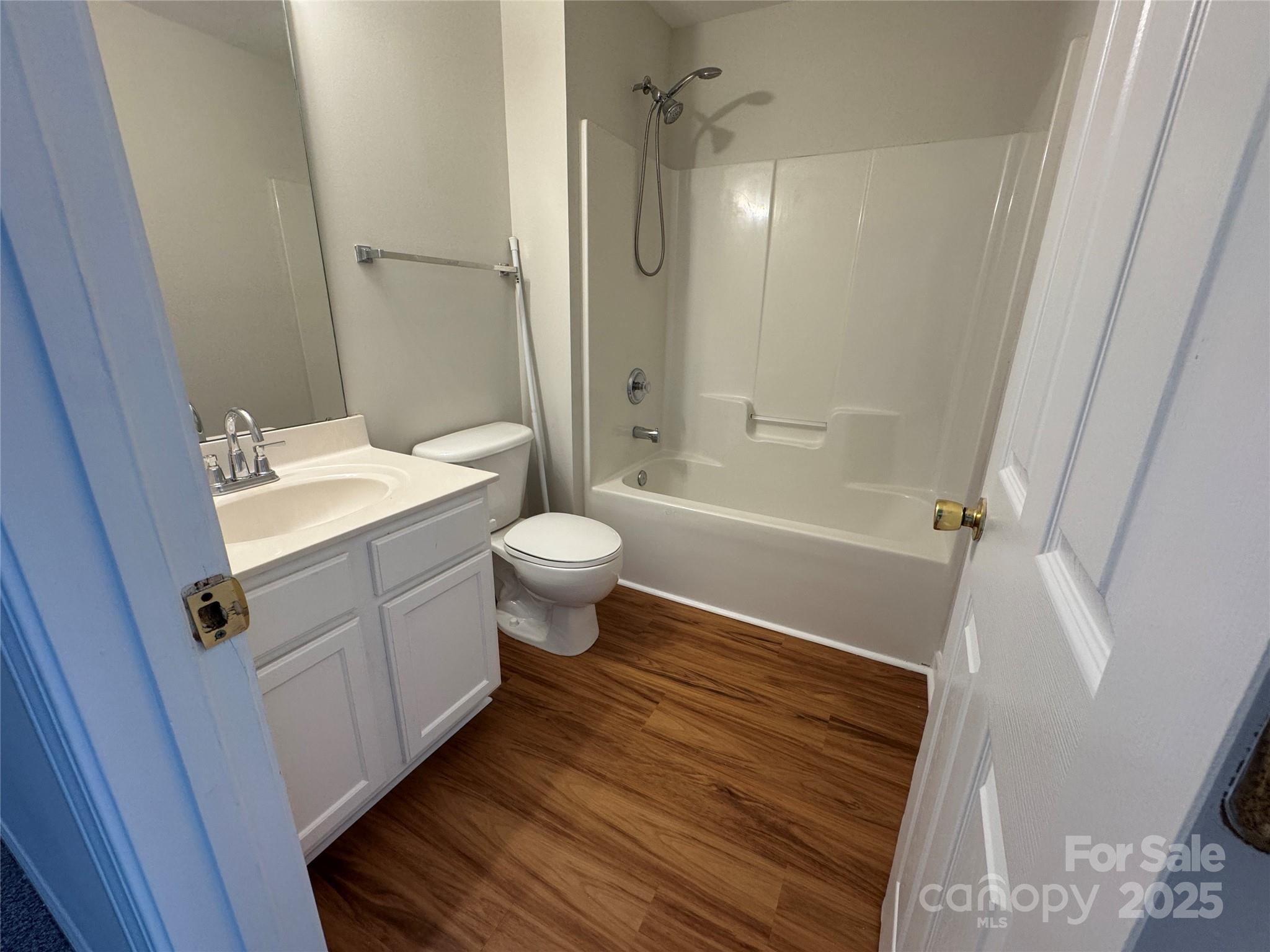 5506 Rogers Road Indian Trail, NC 28079 - Photo 28 of 30 a bathroom with a sink toilet a mirror and shower