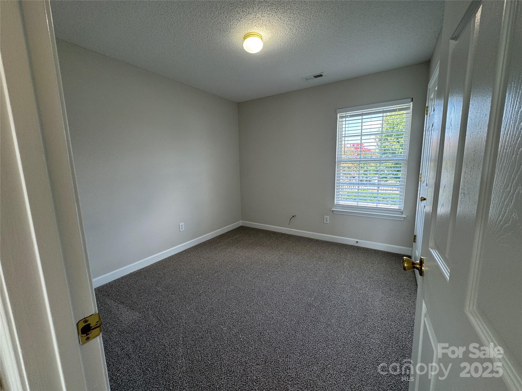 5506 Rogers Road Indian Trail, NC 28079 - Photo 29 of 30 an empty room with a window