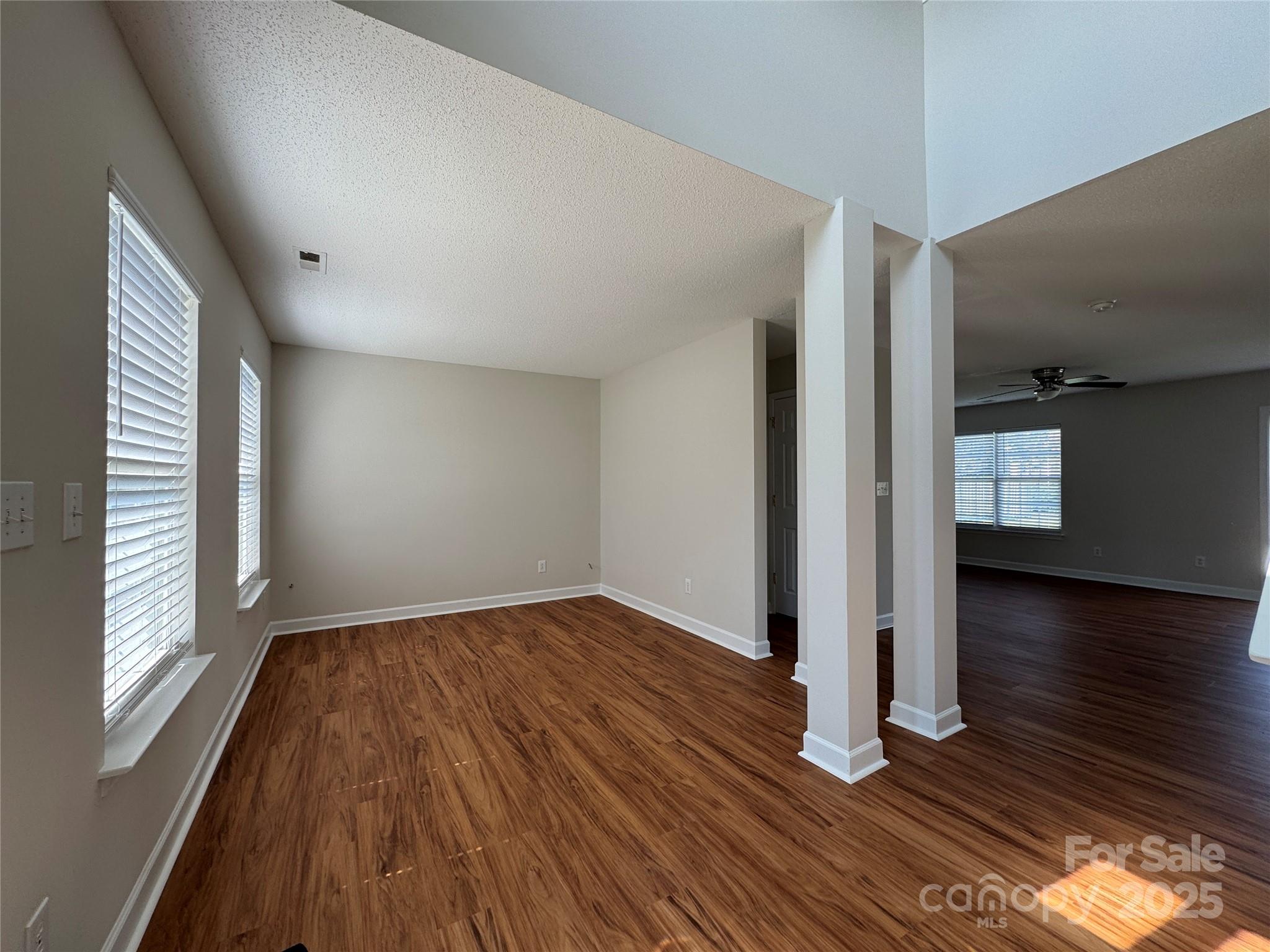 5506 Rogers Road Indian Trail, NC 28079 - Photo 3 of 30 a view of empty room with wooden floor and fan