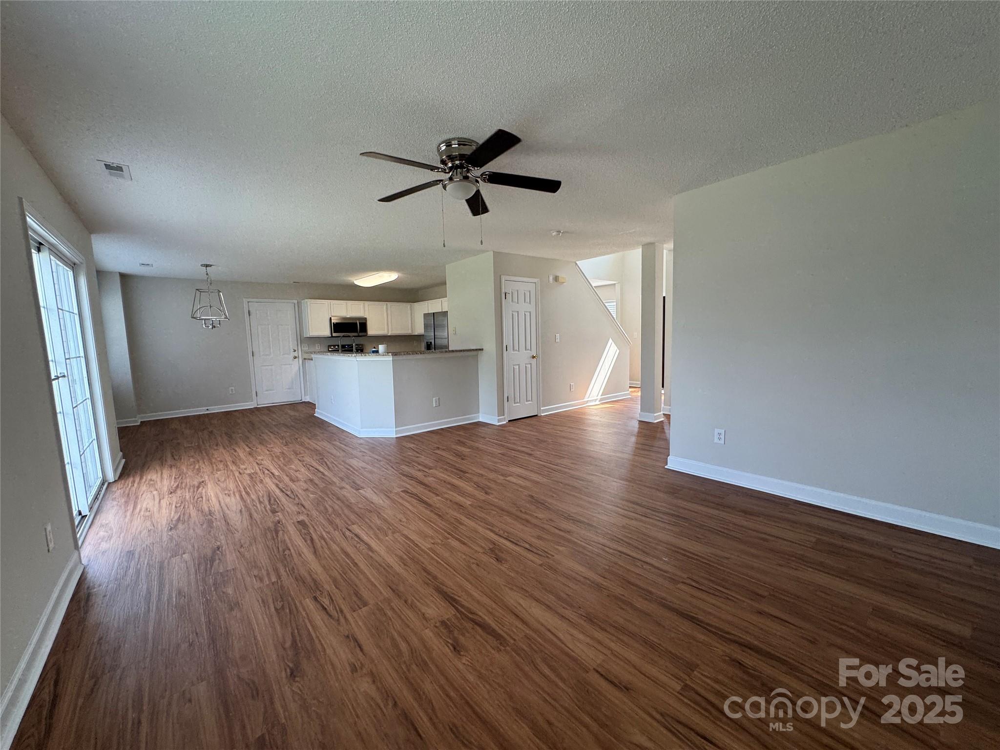 5506 Rogers Road Indian Trail, NC 28079 - Photo 7 of 30 a view of a kitchen with a sink and wooden floor