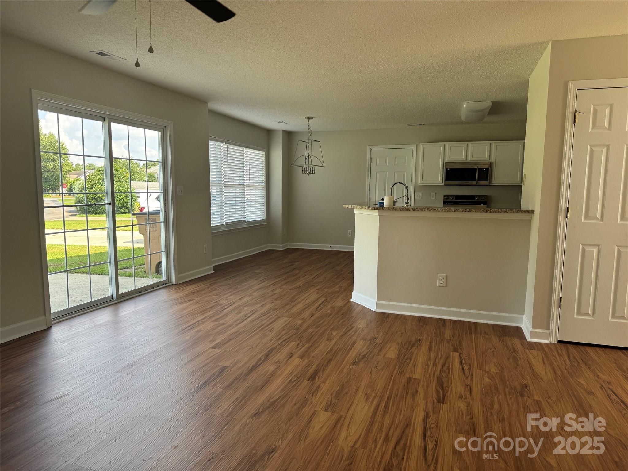 5506 Rogers Road Indian Trail, NC 28079 - Photo 10 of 30 a view of a kitchen with wooden floor and a sink
