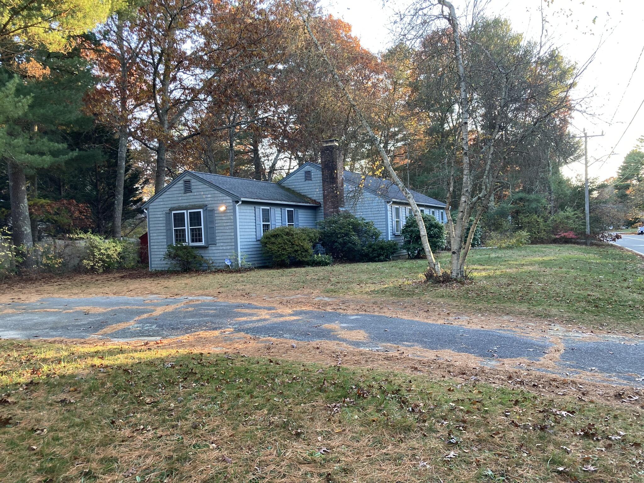 426 Nottingham Drive Centerville, MA 02632 - Photo 2 of 25 a front view of a house with a yard and trees
