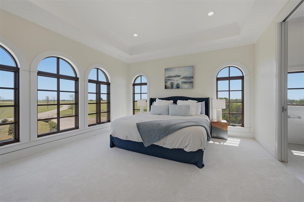 124 Private Road 2202 Decatur, TX 76234 - Photo 19 of 40 a spacious bedroom with a bed a table and large window