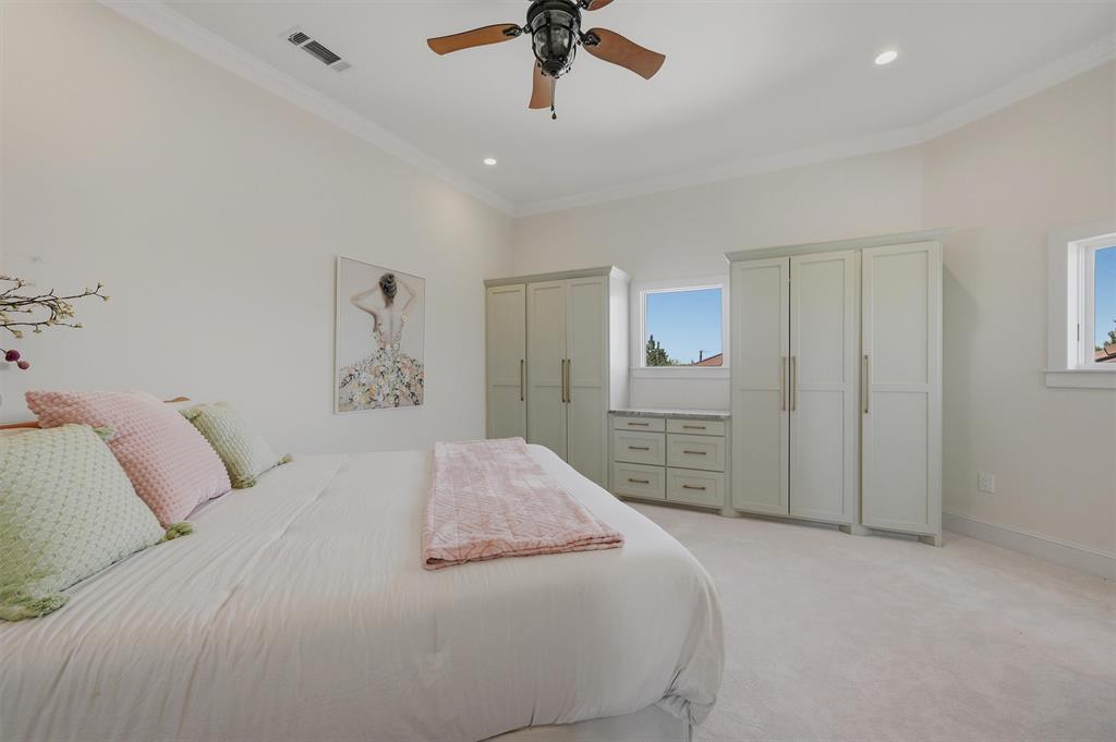 124 Private Road 2202 Decatur, TX 76234 - Photo 20 of 40 a spacious bedroom with a bed and a chandelier