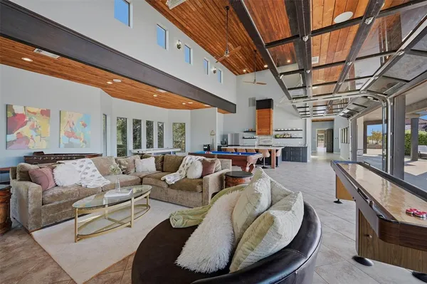 a large kitchen with stainless steel appliances kitchen island granite countertop a table and chairs in it