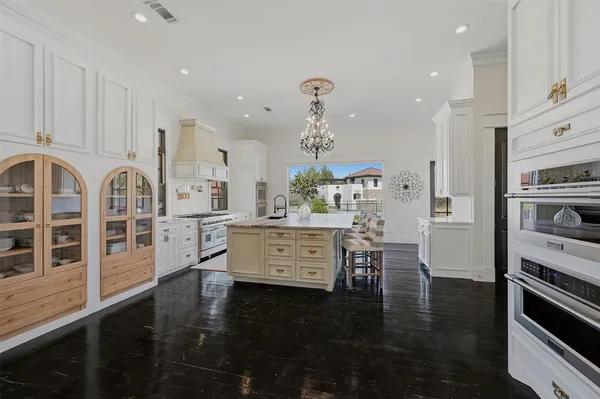 a kitchen with sink stove and refrigerator