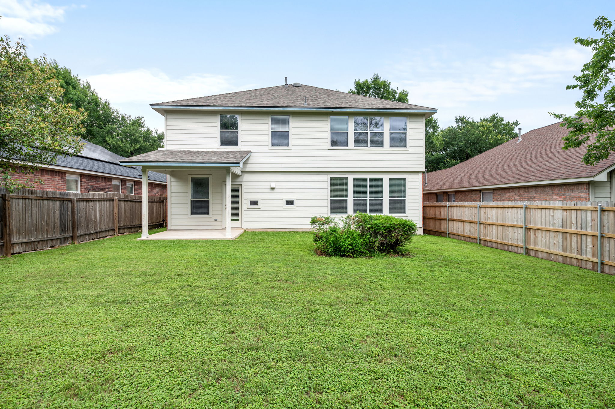 10004 Isle Royale Way Austin, TX 78747 - Photo 28 of 31 A private, fenced backyard offers ample green space and a covered patio for outdoor enjoyment.