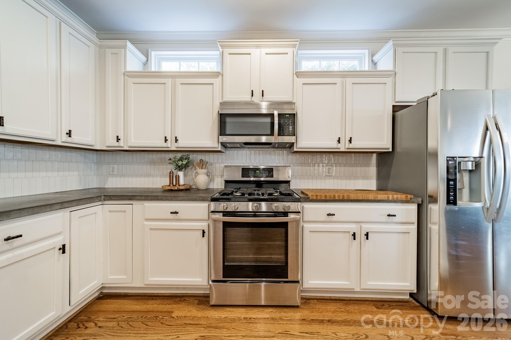 3264 Richard's Crossing Fort Mill, SC 29708 - Photo 16 of 48 a kitchen with stainless steel appliances granite countertop a stove and white cabinets
