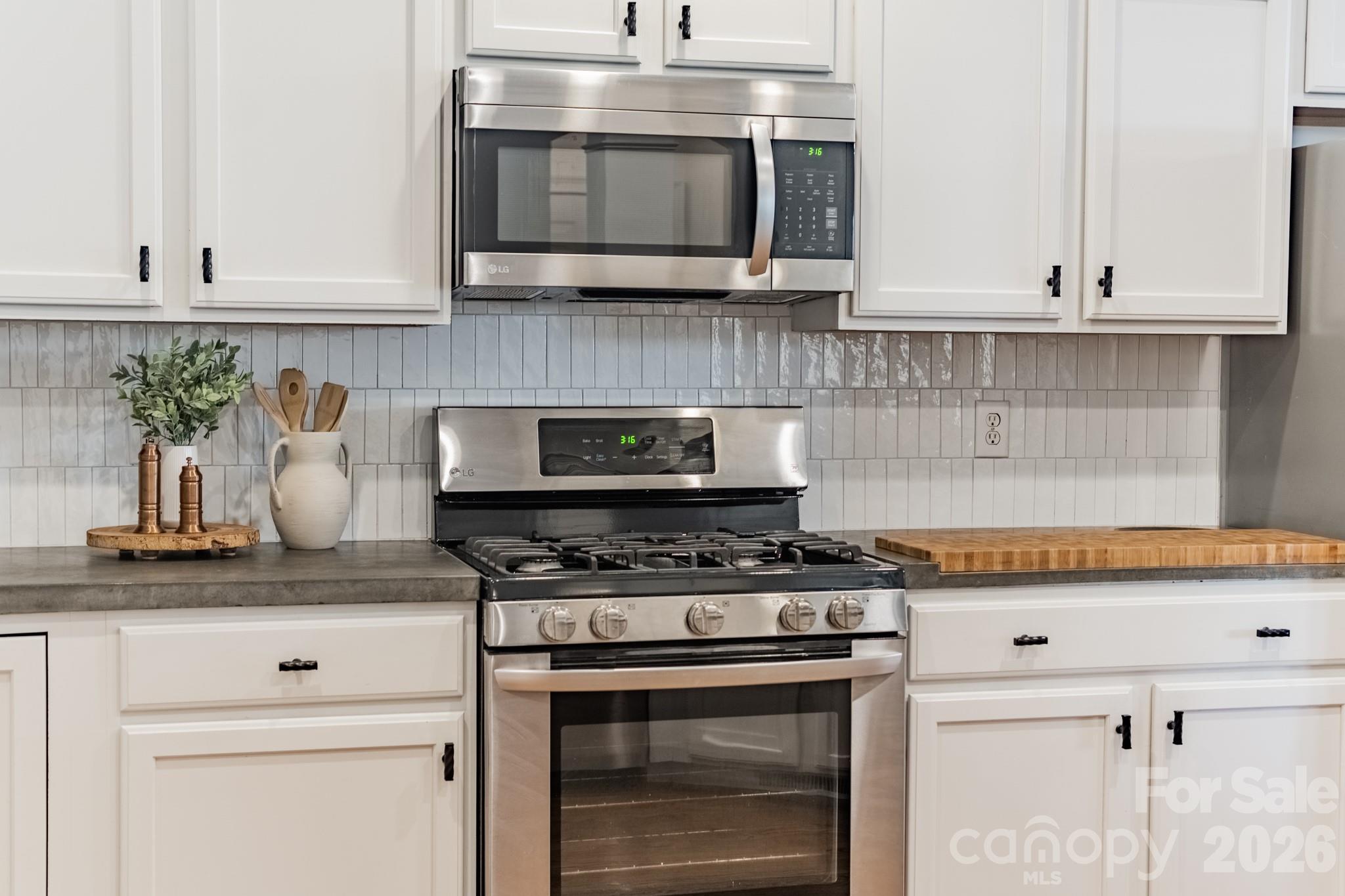 3264 Richard's Crossing Fort Mill, SC 29708 - Photo 19 of 48 a kitchen with stainless steel appliances granite countertop white cabinets and a stove