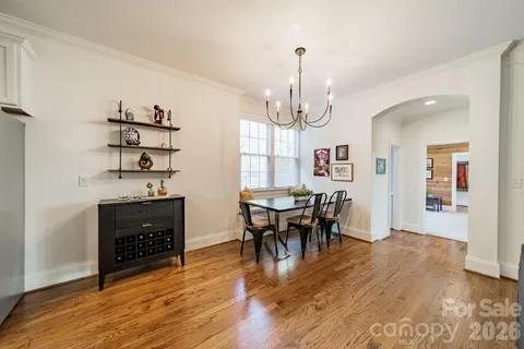 a view of a dining room with furniture wooden floor and chandelier