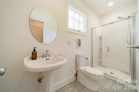 a bathroom with a sink toilet and shower