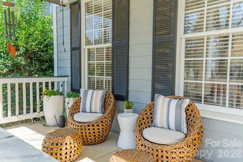 a outdoor living room with furniture and a window