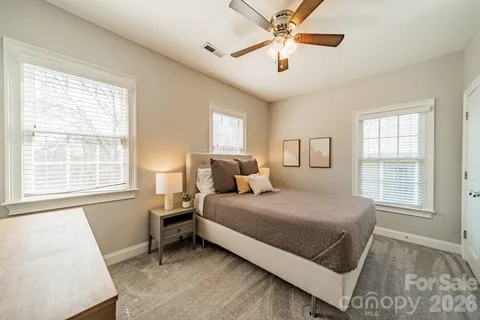 a bedroom with a large bed and a window