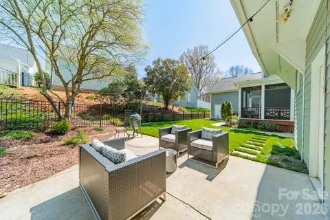 a view of a house with backyard sitting area and garden