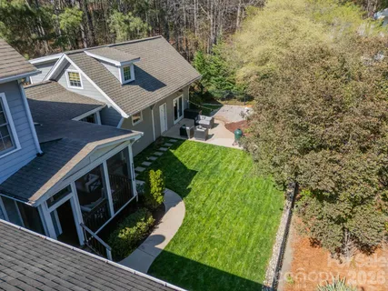 a aerial view of a house with a yard