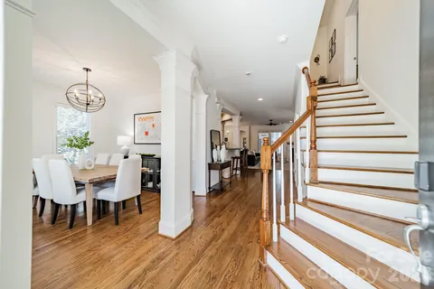 a view of a hallway with wooden floor and stairs