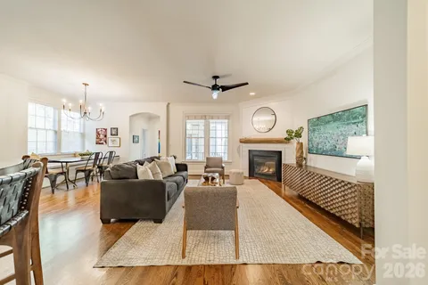 a living room with furniture fireplace and window
