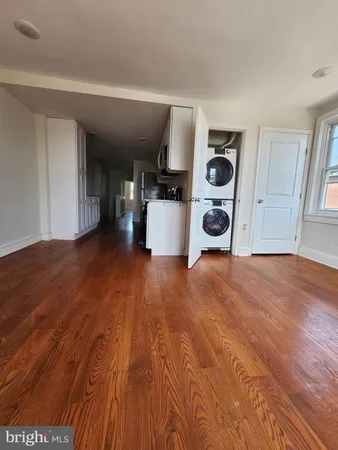 a view of an empty room and wooden floor