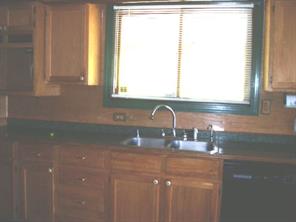 3277 Startown Road Newton, NC 28658 - Photo 4 of 9 a kitchen with a sink a window and cabinets