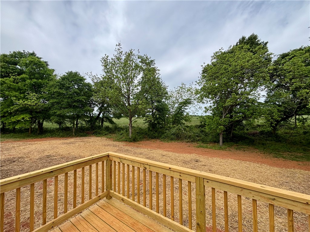 703 Double Springs Road Townville, SC 29689 - Photo 21 of 22 This tranquil property offers a serene outdoor space with a charming deck overlooking lush greenery.