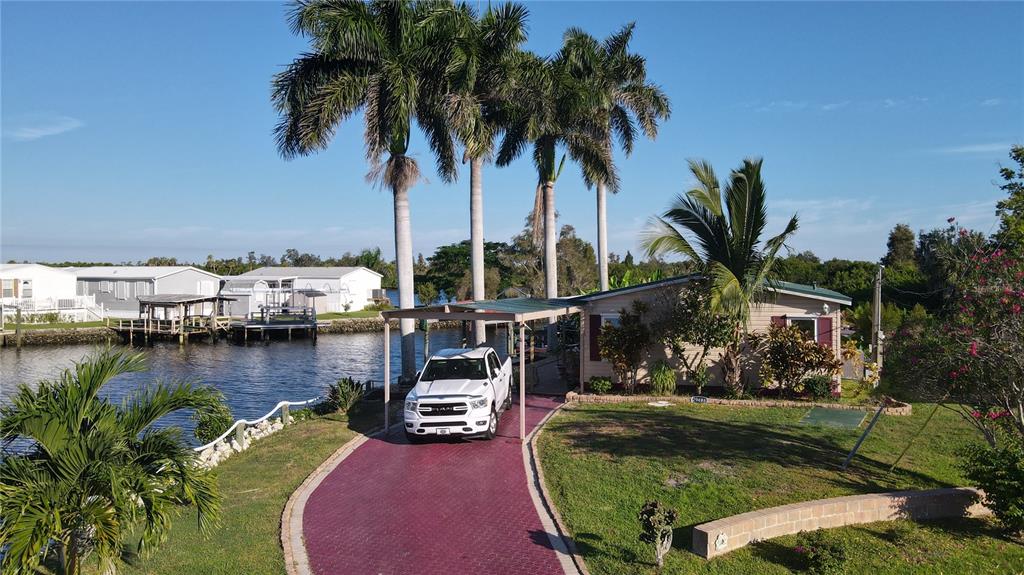 a view of ocean with boats and palm trees