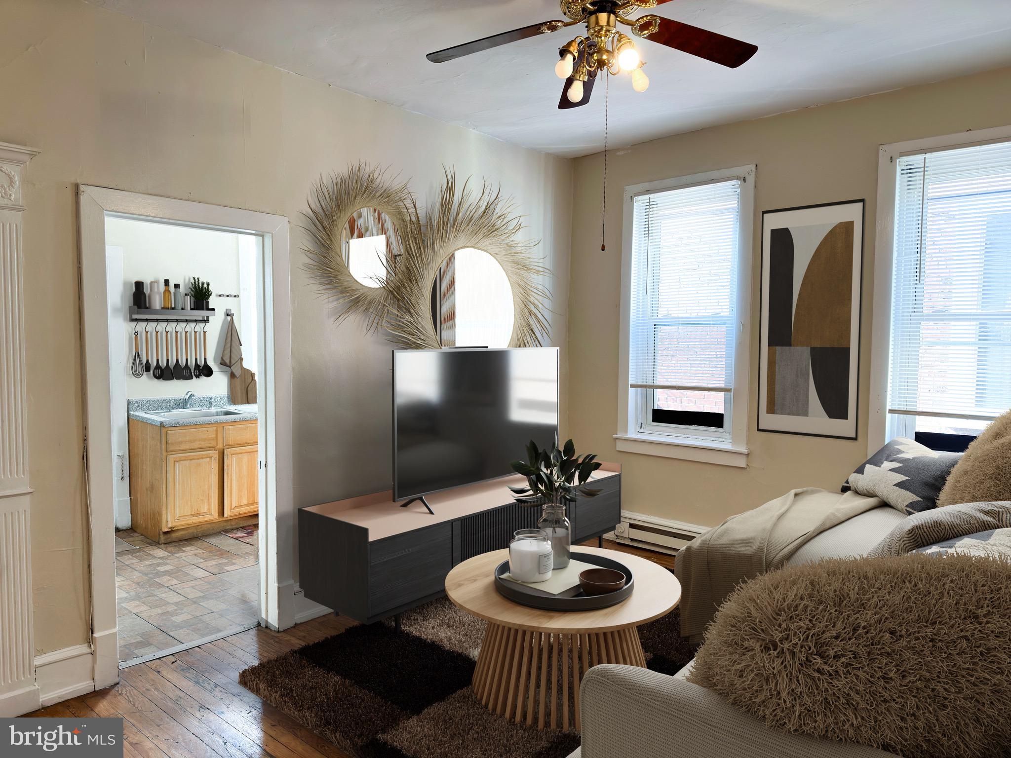 5418 Walnut Street Philadelphia, PA 19139 - Photo 2 of 7 a living room with furniture and a flat screen tv