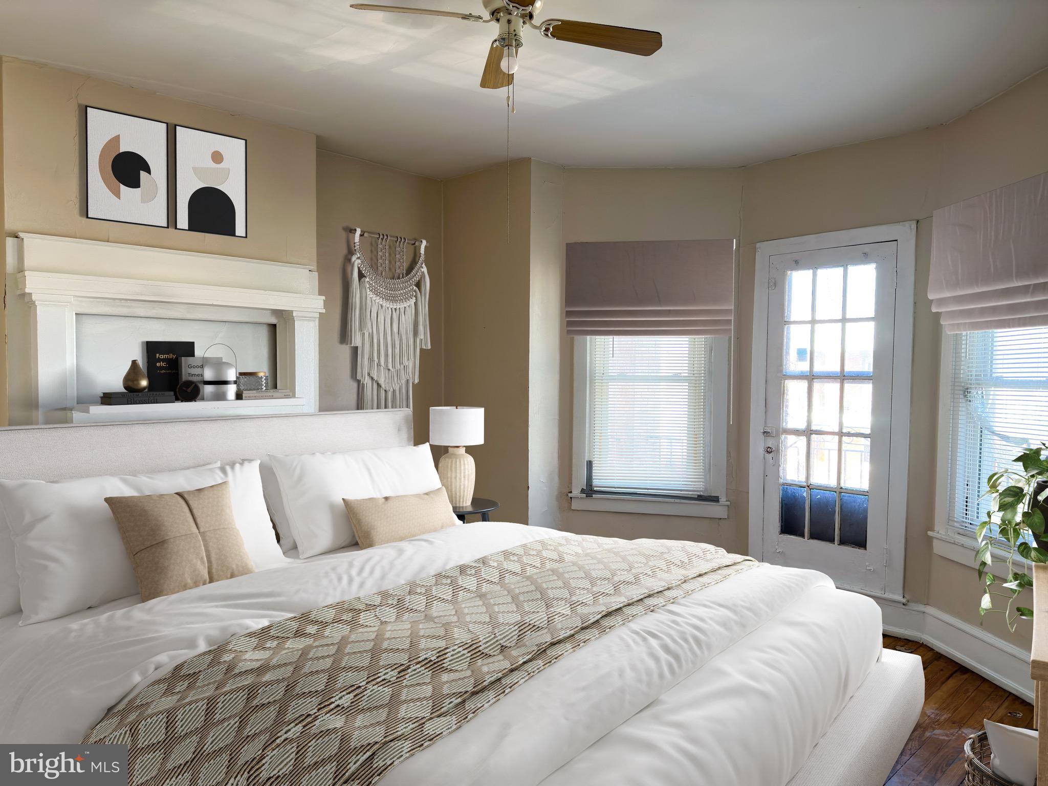 5418 Walnut Street Philadelphia, PA 19139 - Photo 4 of 7 a bedroom with a large bed and a fireplace