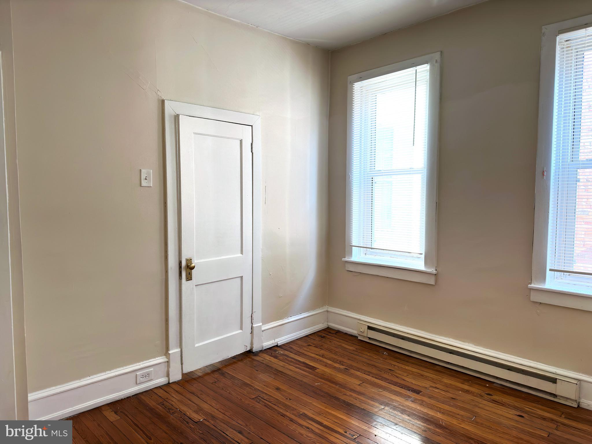 5418 Walnut Street Philadelphia, PA 19139 - Photo 5 of 7 an empty room with wooden floor and windows