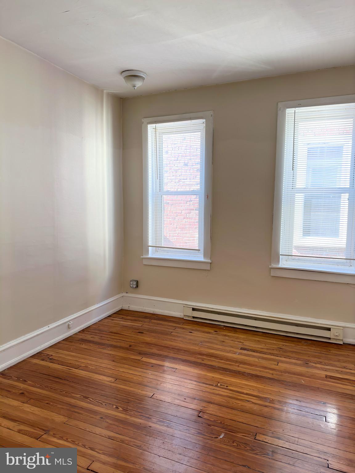 5418 Walnut Street Philadelphia, PA 19139 - Photo 6 of 7 a view of an empty room with wooden floor and a window